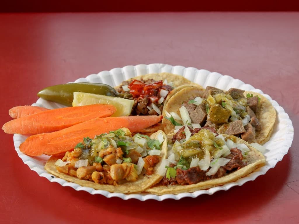 Street tacos with salsa, cilantro and pickled sides