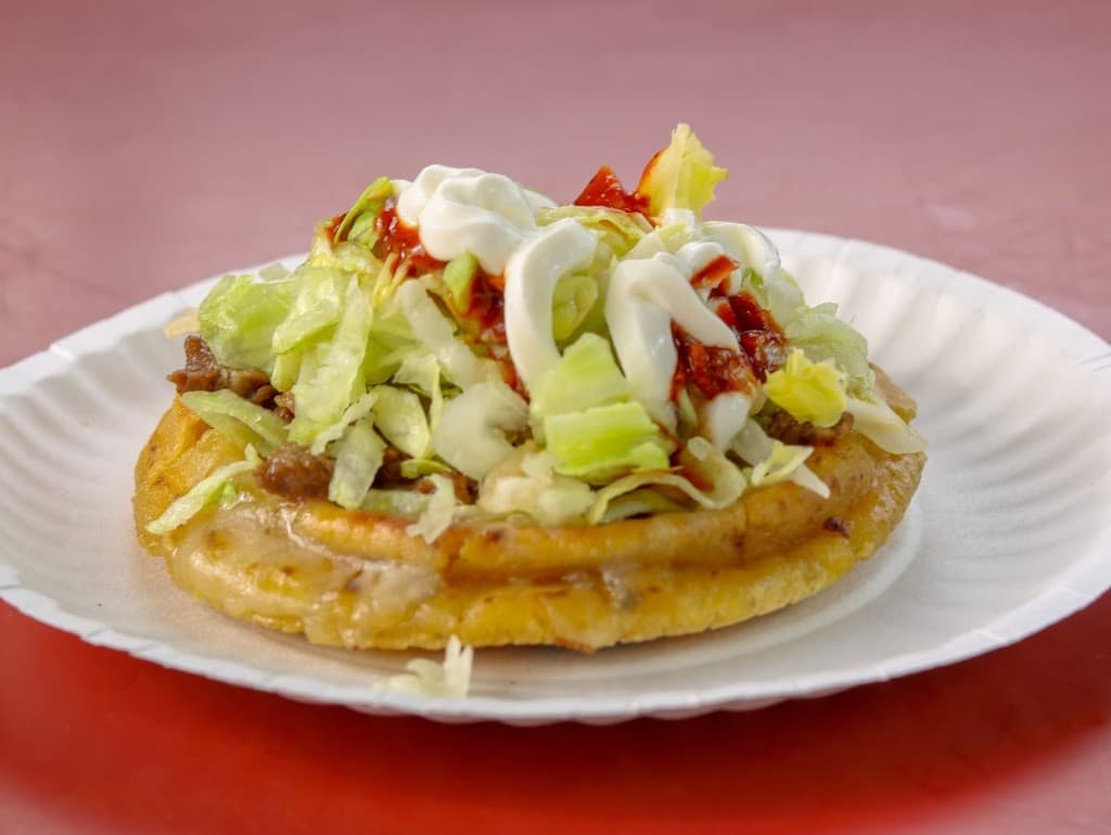Sope with lettuce, crema and salsa